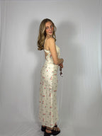 Woman wearing a floral skirt set against a plain background