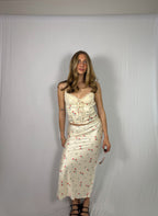 Woman wearing a floral skirt set against a plain white background