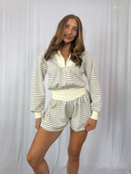 Woman wearing a striped romper with a white background