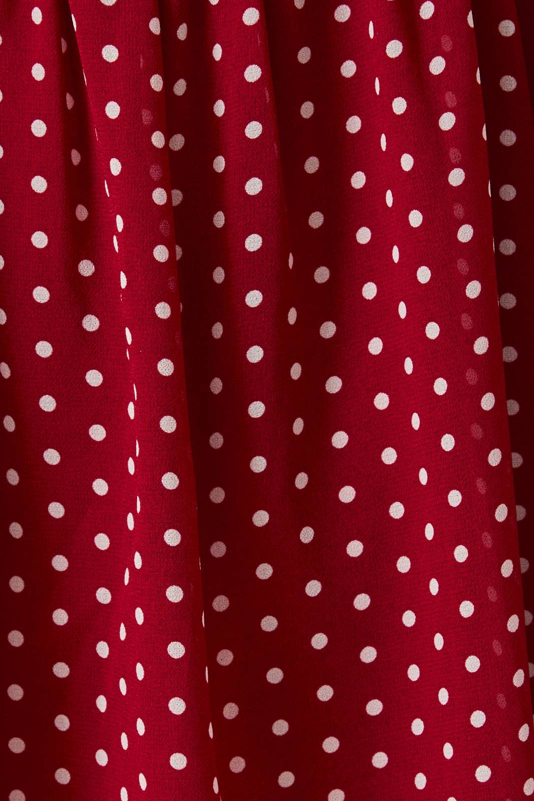 Close-up of red fabric with white polka dots